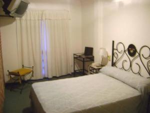 En eller flere senge i et værelse på Hotel Brisolei