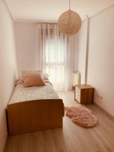 a bedroom with a bed and a large window at Apartamento Rio San Isidro 1 in Felechosa