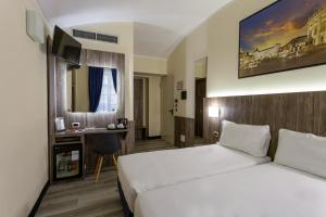 Postel nebo postele na pokoji v ubytování Hotel Urbani