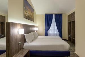 Postel nebo postele na pokoji v ubytování Hotel Urbani