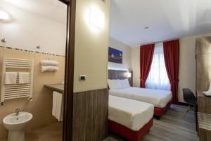 Postel nebo postele na pokoji v ubytování Hotel Urbani