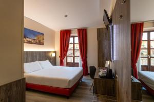 Postel nebo postele na pokoji v ubytování Hotel Urbani