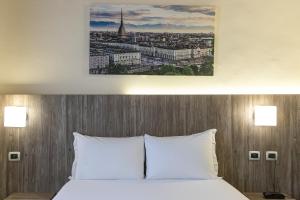 Postel nebo postele na pokoji v ubytování Hotel Urbani