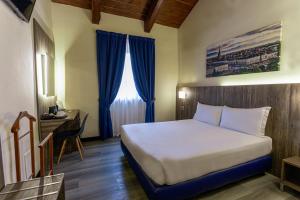 מיטה או מיטות בחדר ב-Hotel Urbani