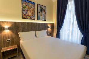 Postel nebo postele na pokoji v ubytování Hotel Urbani