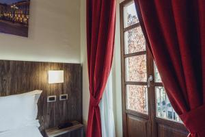 Postel nebo postele na pokoji v ubytování Hotel Urbani