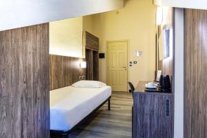 Postel nebo postele na pokoji v ubytování Hotel Urbani