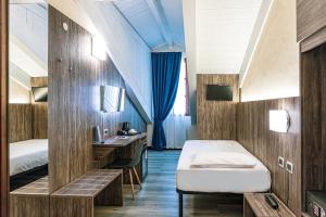 Postel nebo postele na pokoji v ubytování Hotel Urbani