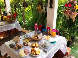 a table with a white table cloth with food on it at Pousada do Mineiro in Trancoso