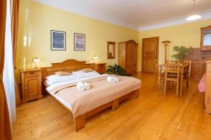 a bedroom with a bed with two towels on it at Pension Paseka in Litomyšl