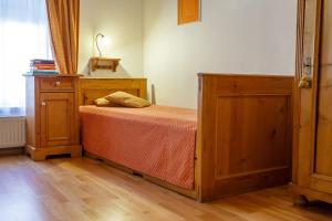 a bedroom with a bed and a cabinet and a window at Pension Paseka in Litomyšl