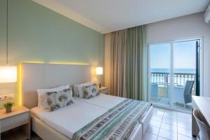 a hotel room with a bed and a balcony at Hotel Rossis in Mesongi