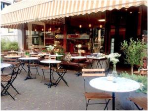 a group of tables and chairs outside of a restaurant at Bookstor Atelier in The Hague