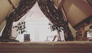 a window in a room with curtains on it at Bookstor Hotel in The Hague