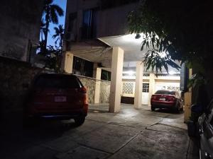 a car parked in front of a house at night at IOW4 LM Junior Suite in Acapulco