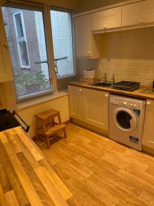 a kitchen with a washing machine and a sink at Market View in Eyemouth