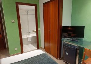 a bathroom with a sink and a toilet at Hotel Iris in Granollers