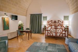 
a living room filled with furniture and a large window at Masseria Torre Spagnola in Matera
