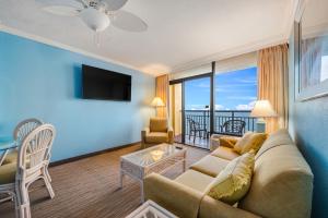 a living room with a couch and a tv at Direct oceanfront, separate bedroom condo, 9th floor, unbelievable views! in Myrtle Beach