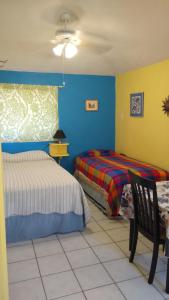 מיטה או מיטות בחדר ב-Coco Cabanas Loreto