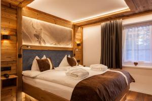Postel nebo postele na pokoji v ubytování Silvana Mountain Hotel