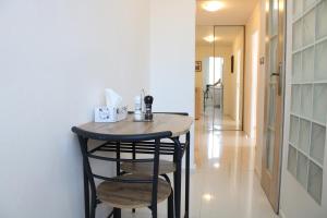 a small table in a hallway with a stool at Apartment with balcony, Humenné SK in Humenné