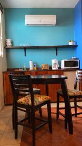 a table and two chairs in a kitchen with a counter at Family Guest House in Quebradillas