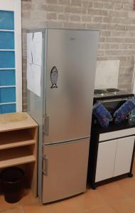 a refrigerator in a kitchen next to a counter at Studio Voluntário in Hradec Králové