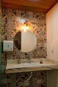 a bathroom with a sink and a mirror at Pousada Vila Catarina in Ouro Preto