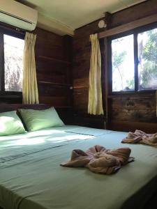 a bedroom with two beds with towels on them at Papa Pippo Otres Village in Sihanoukville