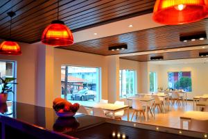 a restaurant with tables and chairs and red lights at Hotel Terrazas by CPH in Villa Carlos Paz