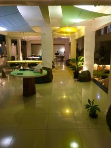 a lobby with a table and chairs in a building at NIASHA in Mangalore