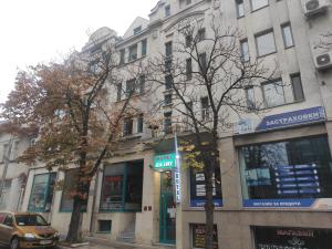 a building with a car parked in front of it at Hotel Oazis in Haskovo