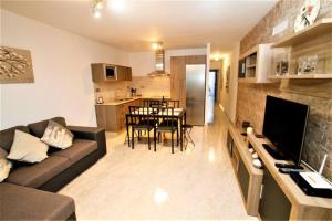 a living room with a couch and a dining room at Apartamento Yale in Tías