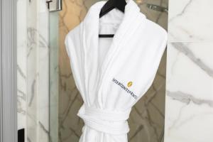 a white robe hanging in front of a window at InterContinental Sydney Double Bay, an IHG Hotel in Sydney