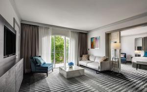 a living room with a couch and a tv at InterContinental Sydney Double Bay, an IHG Hotel in Sydney