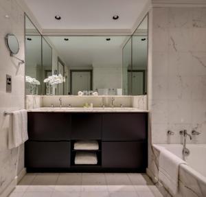 a bathroom with a mirror and a bath tub at InterContinental Sydney Double Bay, an IHG Hotel in Sydney