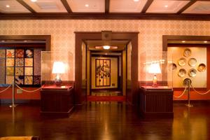 a room with two tables with vases on them at Kanazawa Hakuchoro Hotel Sanraku -Natural Hot Spring- in Kanazawa