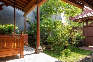 a dog standing under a pavilion in a garden at Rumah Ukhi Guest House in Yogyakarta