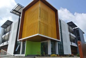 a building with a yellow and white facade at V.O.P Suite in Chaweng