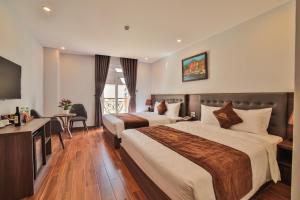 Ένα ή περισσότερα κρεβάτια σε δωμάτιο στο Dalat Paradise Hotel
