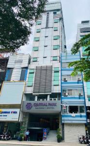 a tall building with a sign on the front of it at Central Park Saigon Hotel in Ho Chi Minh City