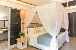 a bedroom with a bed with a canopy at The Forty Eight Resort Candidasa in Candidasa +141 photos