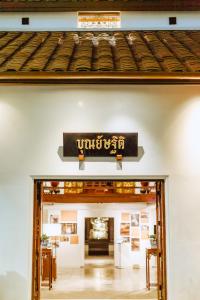 an entrance to a building with a sign over the door at Punyashthiti villa in Chanthaburi