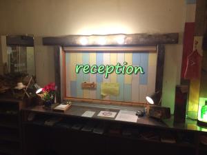 a reception window with the word reception on it at ふる郷荘Furusato Furano in Furano