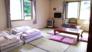 a living room with a couch and a table at ふる郷荘Furusato Furano in Furano