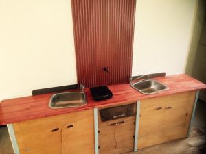 a kitchen with two sinks and a wooden counter at ふる郷荘Furusato Furano in Furano