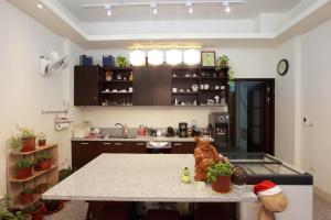 a kitchen with a table with a stuffed bear on it at Travelers Fu-Home in Hualien City