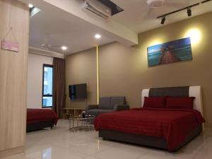 a bedroom with a bed and a couch and a tv at #4 Summer Studio - One South in Seri Kembangan