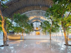 重慶的住宿－重庆来福士洲际酒店，一座带天花板的建筑里,有树木的大堂